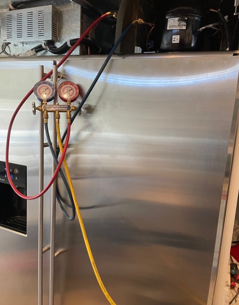 Refrigerator with Yellow Jacket refrigerant manifold gauges attached for sealed system service